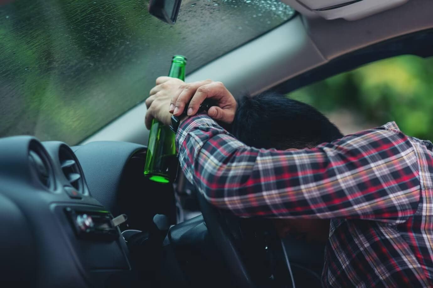 Visual portrayal of a man visibly impaired inside his car, spotlighting Gurvis Personal Injury Lawyers and their specialization in legal matters related to drunk driving. The image is contextually aligned with the page, emphasizing the firm's expertise as Drunk Driver Lawyers.